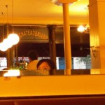 Cousin Coug peeks at her reflection and the front entrance of Chateaubriand.